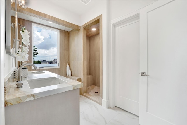 bathroom featuring a shower and vanity