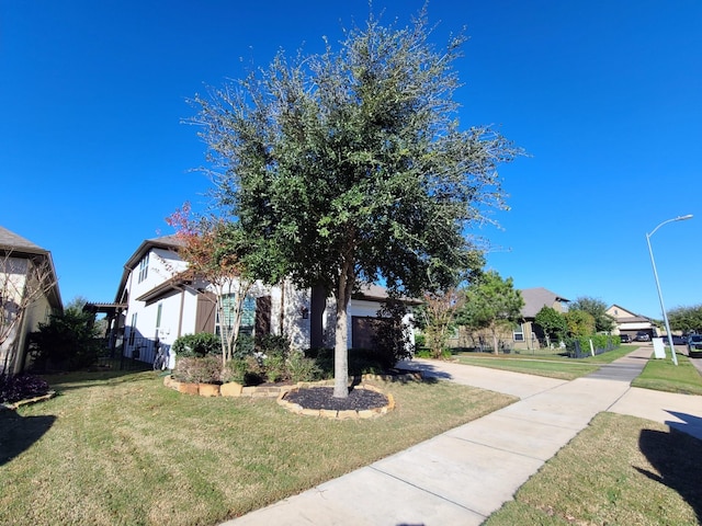 obstructed view of property with a front lawn