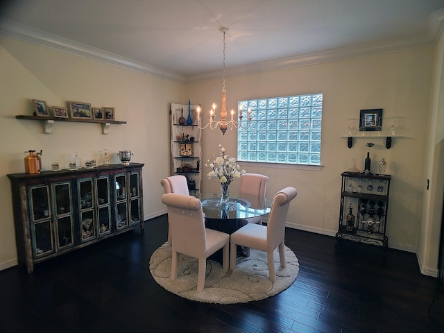 dining area with dark wood-type flooring, a notable chandelier, and ornamental molding