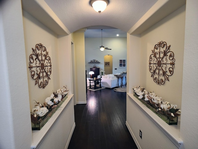 corridor with dark hardwood / wood-style flooring