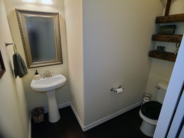 bathroom featuring hardwood / wood-style floors and toilet