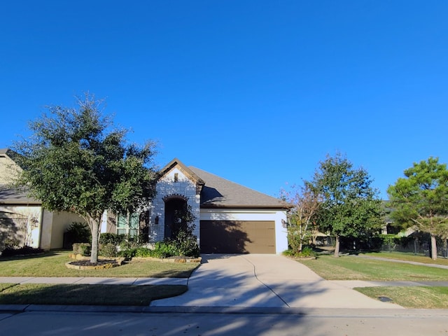 view of front of home featuring a garage and a front lawn