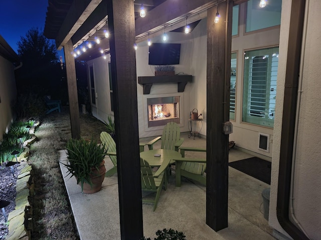 patio at night with an outdoor fireplace