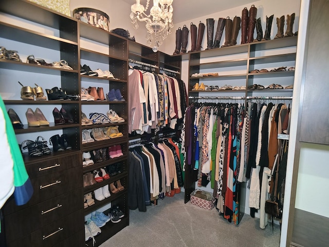 spacious closet featuring carpet and a notable chandelier