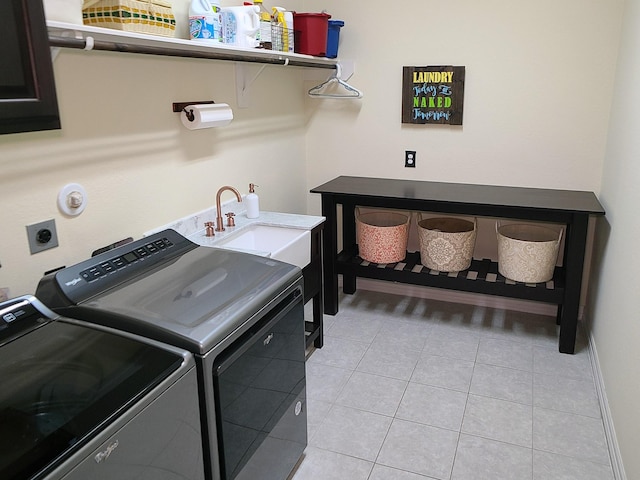 laundry room with sink, light tile patterned flooring, and washer and dryer