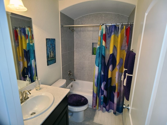 full bathroom with tile patterned flooring, vanity, toilet, and shower / bath combo with shower curtain