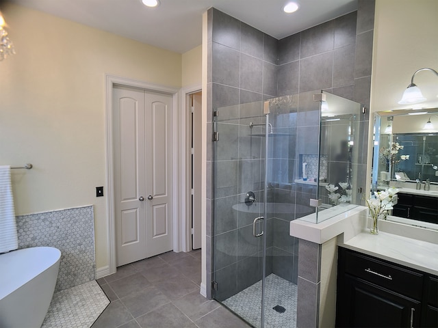 bathroom with tile patterned flooring, vanity, and shower with separate bathtub