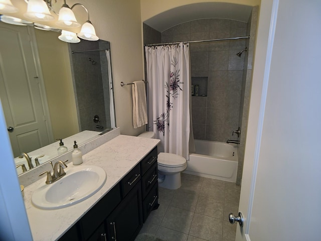 full bathroom with tile patterned floors, shower / bathtub combination with curtain, vanity, and toilet