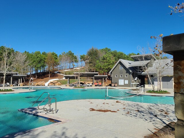 view of swimming pool with a patio