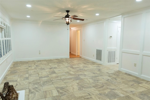 empty room featuring ceiling fan and crown molding