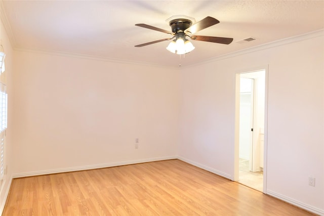 spare room with ceiling fan, ornamental molding, and light hardwood / wood-style flooring