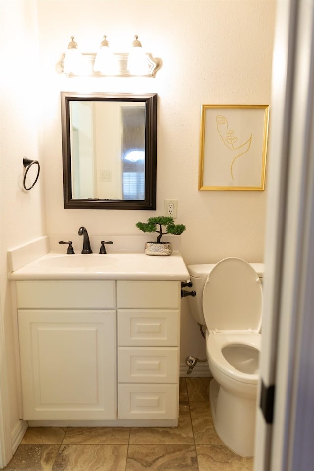 bathroom featuring toilet and vanity