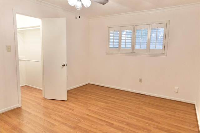 unfurnished bedroom featuring ornamental molding, ceiling fan, and light wood-type flooring