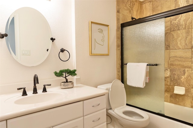 full bathroom with toilet, bath / shower combo with glass door, and vanity