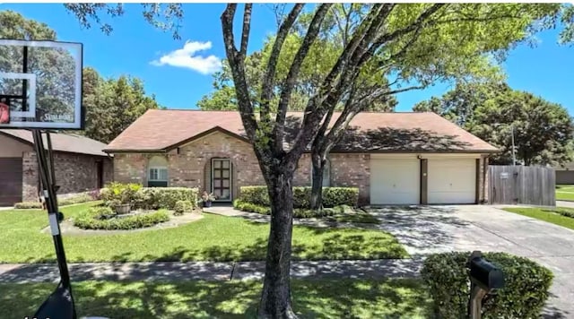 view of front of home with a front lawn and a garage