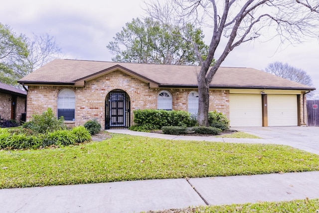 ranch-style house featuring a front yard and a garage