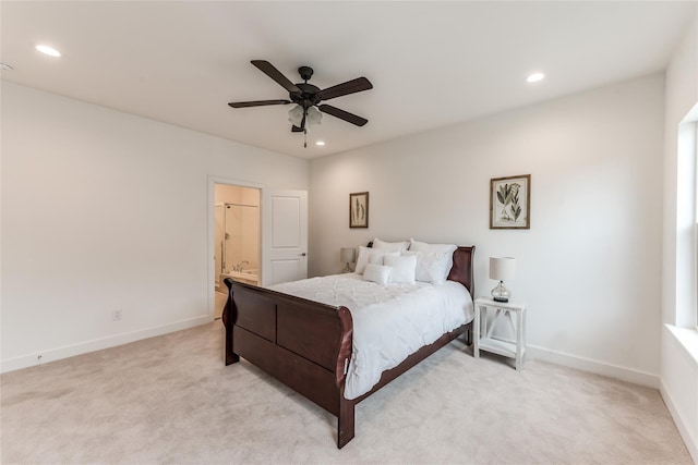 bedroom with ensuite bath, ceiling fan, and light carpet