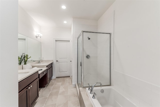 bathroom with vanity and separate shower and tub