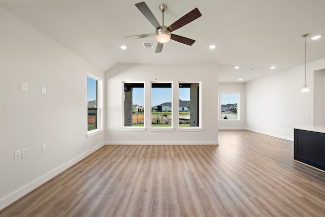 9760 Rockwell Dr, Willis, TX 77318 - unfurnished living room featuring light wood-style floors, ceiling fan, recessed lighting, and vaulted ceiling