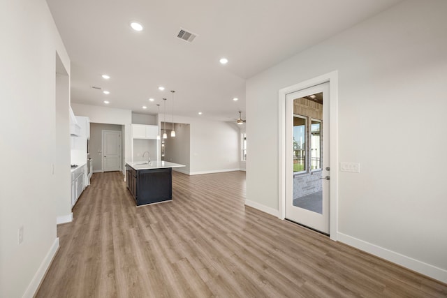 9760 Rockwell Dr, Willis, TX 77318 - unfurnished living room featuring recessed lighting and light wood-style floors