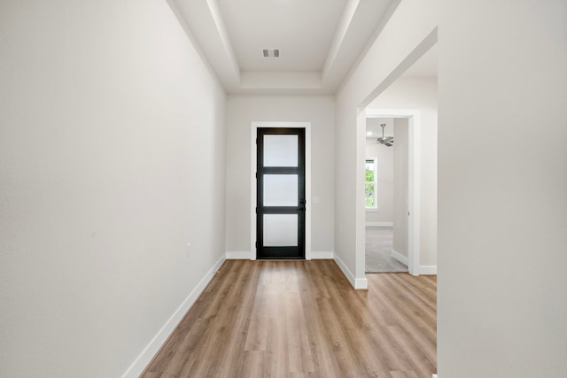 9760 Rockwell Dr, Willis, TX 77318 - entryway with light wood-style floors and a tray ceiling