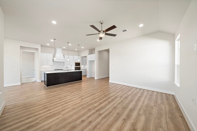 9760 Rockwell Dr, Willis, TX 77318 - unfurnished living room with a ceiling fan, light wood-type flooring, recessed lighting, and lofted ceiling