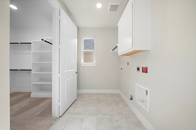 9760 Rockwell Dr, Willis, TX 77318 - washroom with hookup for an electric dryer, cabinet space, recessed lighting, and light tile patterned floors