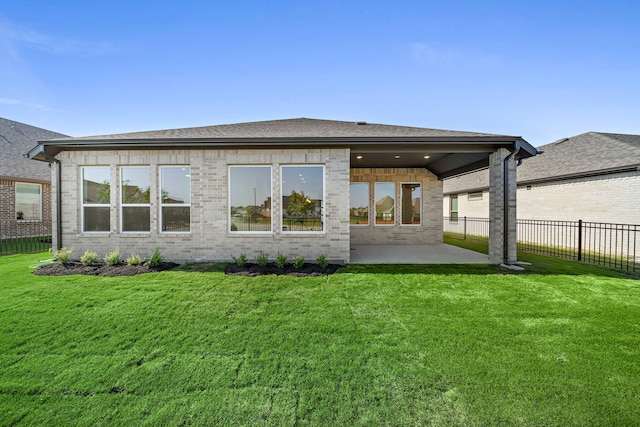 9760 Rockwell Dr, Willis, TX 77318 - rear view of house with a patio, brick siding, and roof with shingles
