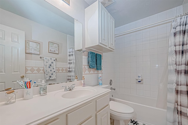 full bathroom with vanity, shower / bathtub combination with curtain, toilet, and tile walls