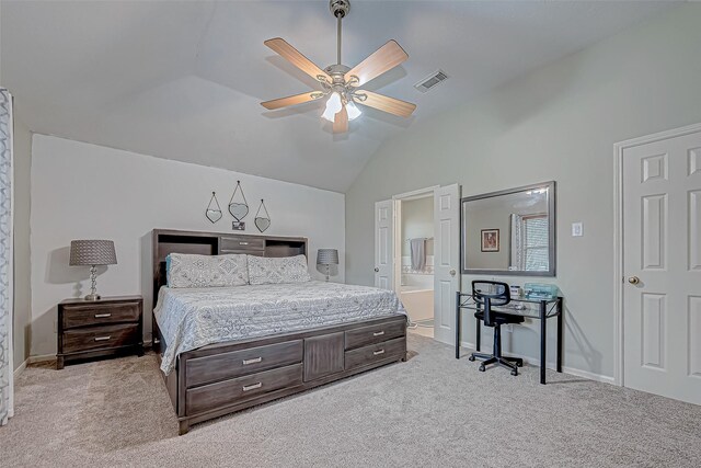 carpeted bedroom with ceiling fan, ensuite bathroom, and vaulted ceiling