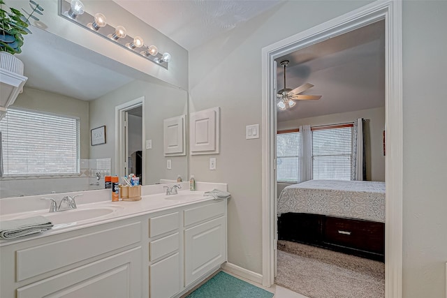 bathroom with vanity, ceiling fan, and a healthy amount of sunlight