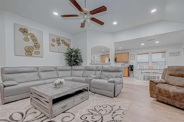 living room with ceiling fan and light wood-type flooring