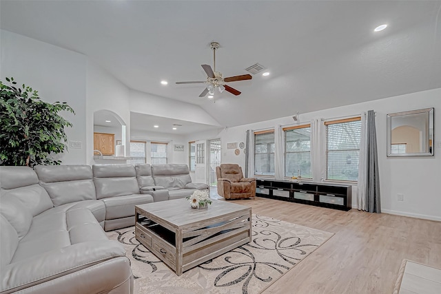 living room featuring light hardwood / wood-style floors, high vaulted ceiling, and ceiling fan