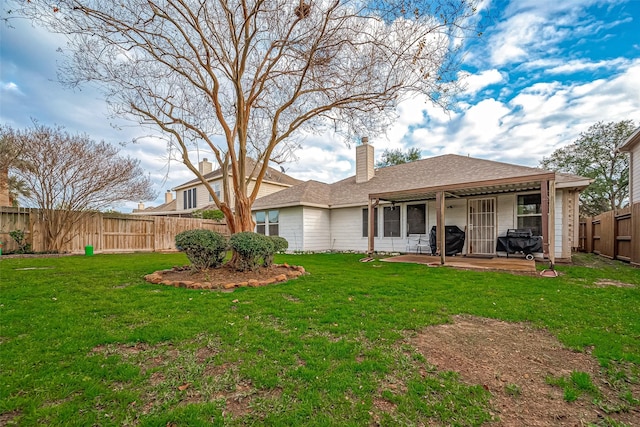 rear view of property with a patio area and a lawn