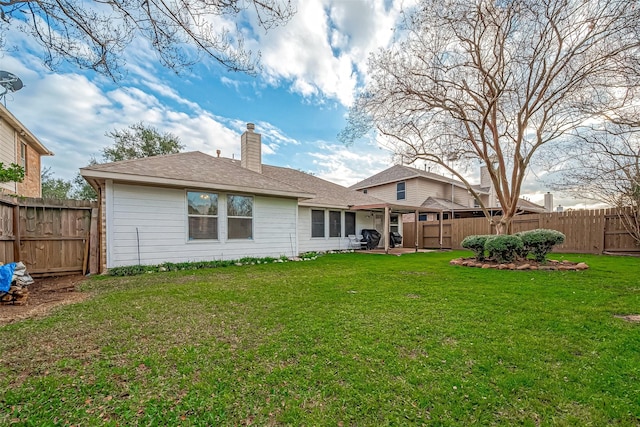 back of property with a lawn