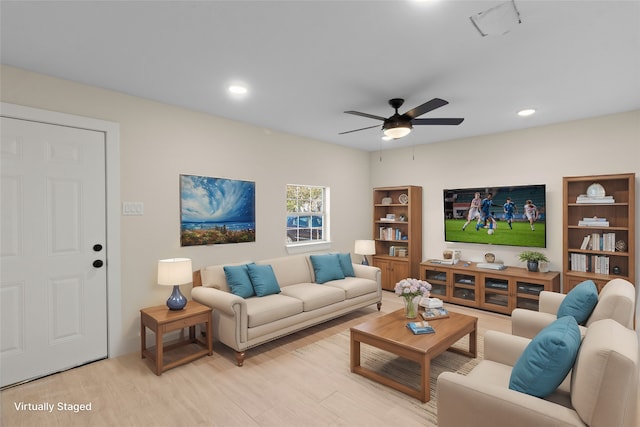 living room featuring light hardwood / wood-style floors and ceiling fan