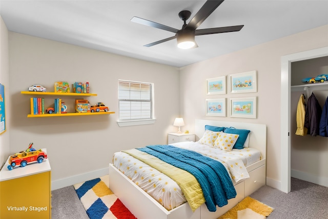 carpeted bedroom featuring ceiling fan and a closet