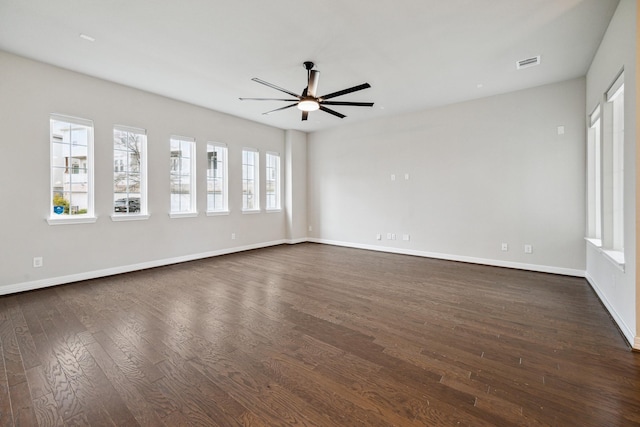 spare room with dark hardwood / wood-style flooring and ceiling fan