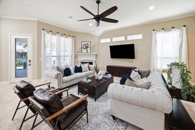 living room featuring ceiling fan, plenty of natural light, ornamental molding, and lofted ceiling