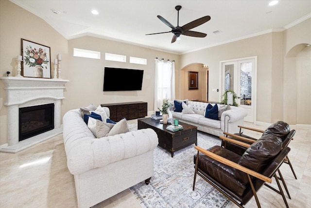 living room with ceiling fan, lofted ceiling, and ornamental molding