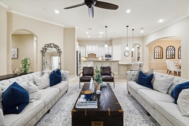 living room featuring ceiling fan and ornamental molding