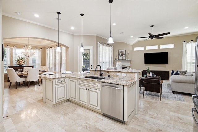 kitchen with a center island with sink, dishwasher, sink, and hanging light fixtures