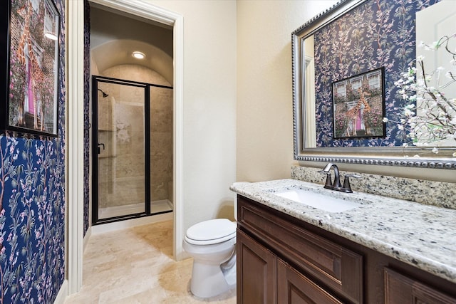 bathroom featuring vanity, toilet, and walk in shower