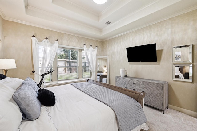 carpeted bedroom featuring a tray ceiling and ornamental molding