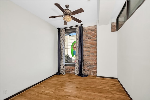 empty room featuring ceiling fan and light hardwood / wood-style flooring