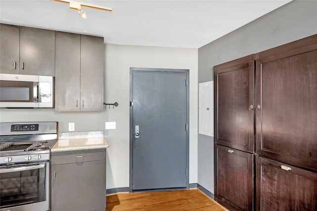 kitchen featuring light hardwood / wood-style floors and appliances with stainless steel finishes