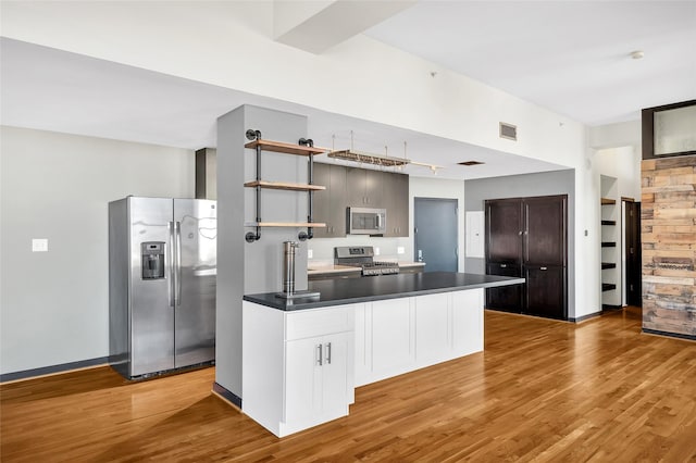 915 Franklin St Unit 3G, Houston, TX 77002 - kitchen featuring dark brown cabinetry, stainless steel appliances, and light hardwood / wood-style flooring
