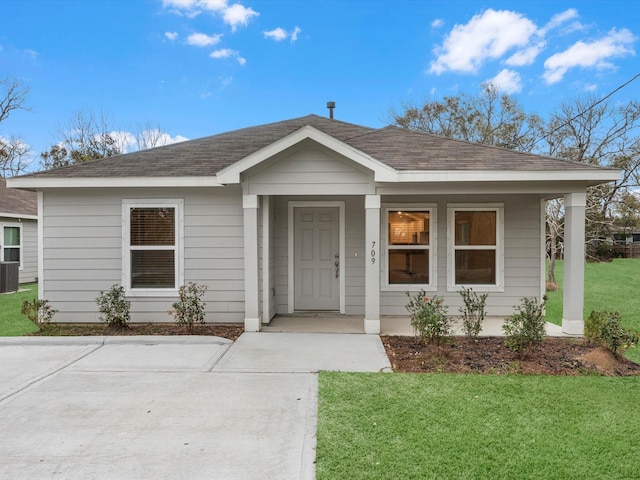 view of front of house featuring covered porch and a front lawn