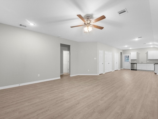 unfurnished living room featuring ceiling fan and light hardwood / wood-style flooring