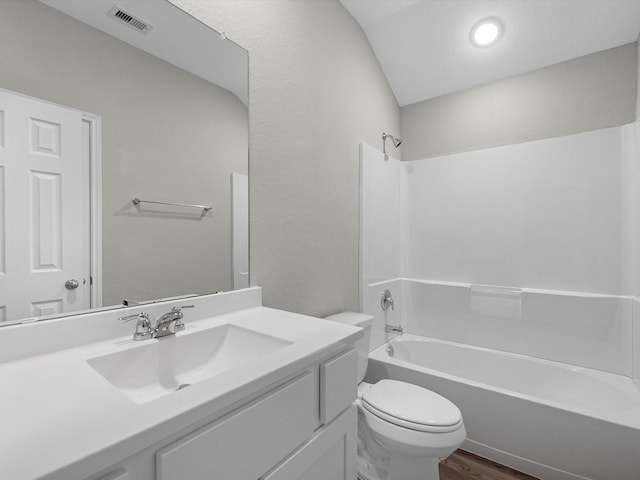 full bathroom featuring wood-type flooring, vaulted ceiling, toilet, shower / tub combination, and vanity